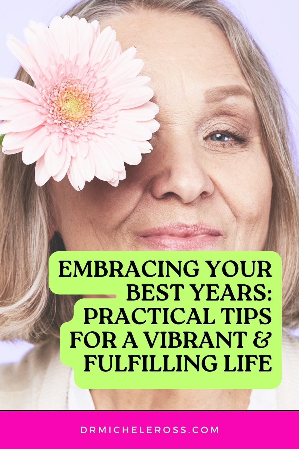 beautiful older woman embracing aging holding pink daisy up to her eye smiling pinterest pin