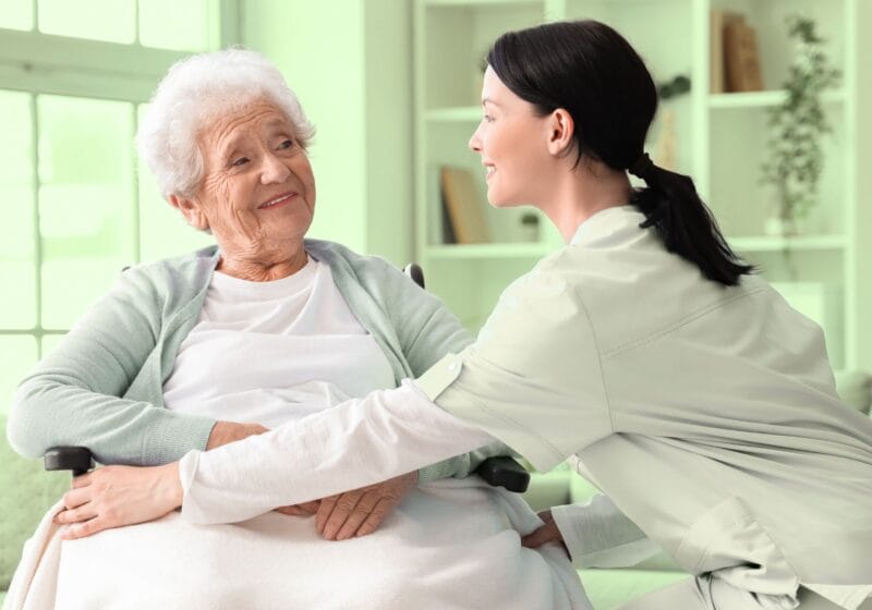 senior woman in a wheelchair being taken care of nurse in palliative care hospice