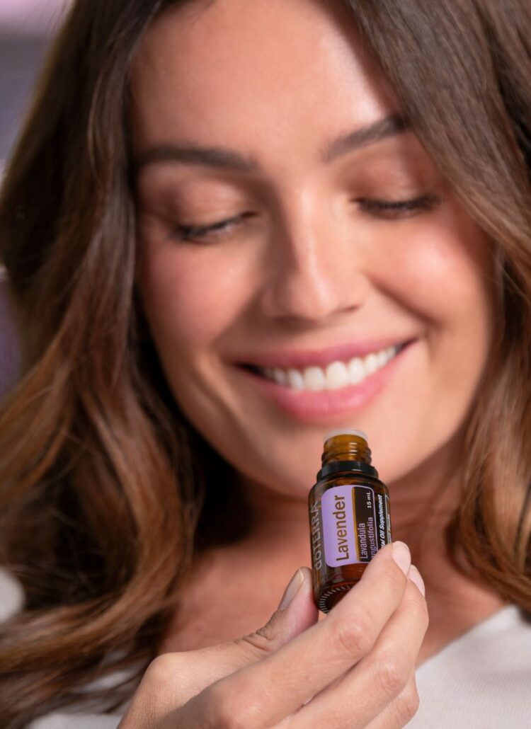 woman holding doterra essential oil lavender for relaxation