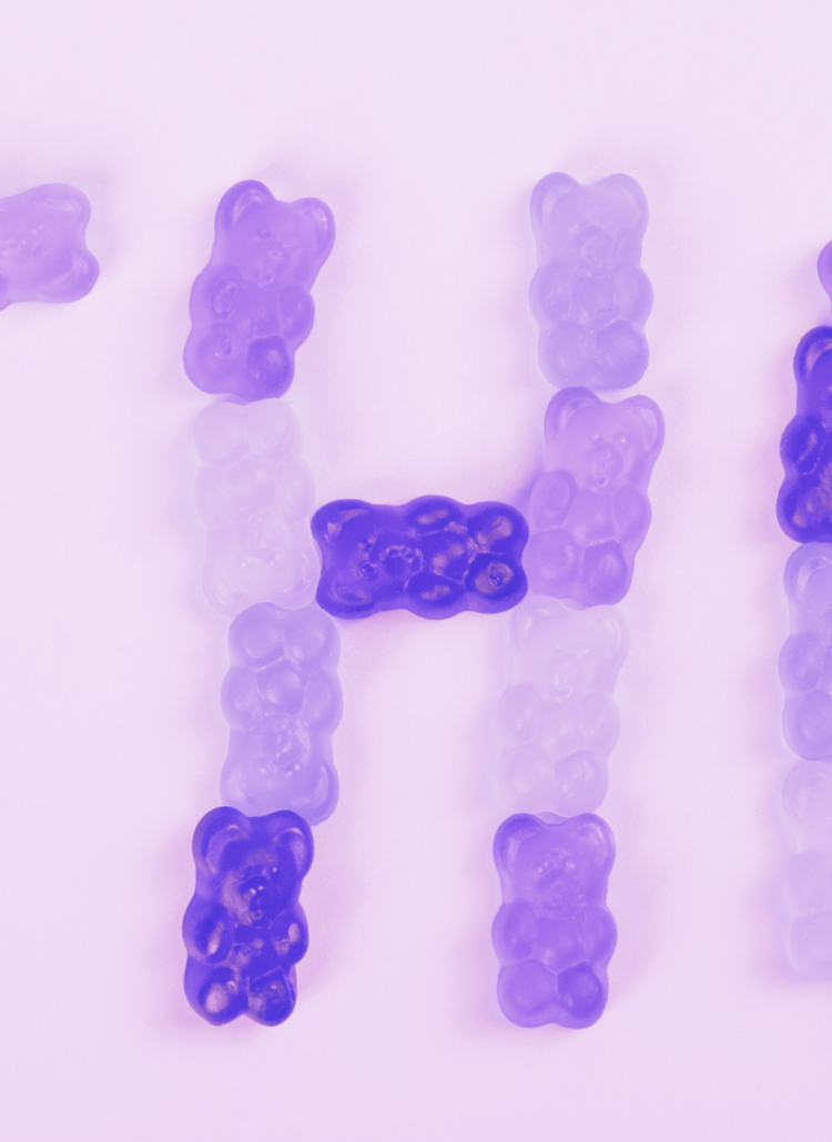 THC spelled out in purple weed gummies made from marijuana