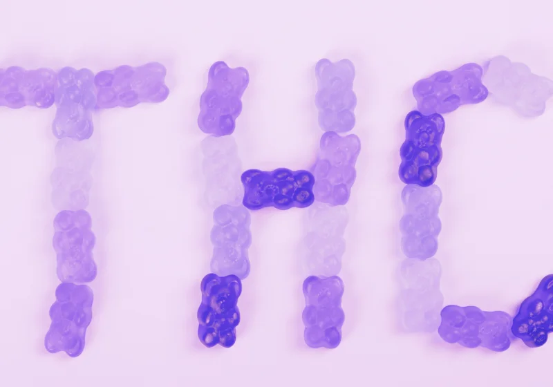 THC spelled out in purple weed gummies made from marijuana