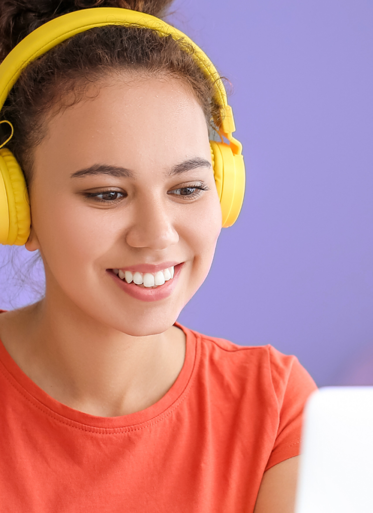 woman wearing yellow headphones taking online course on cannabis