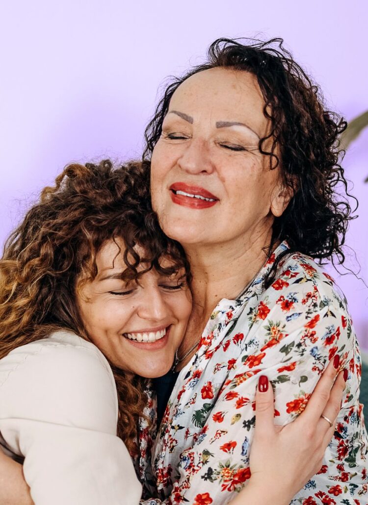 daughter hugging aging mother after conversation about elder care nursing home