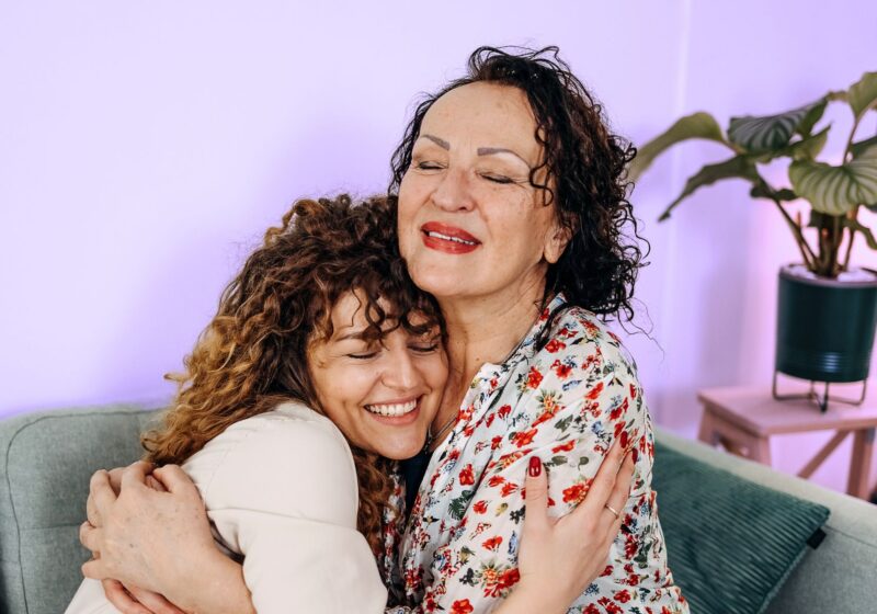 daughter hugging aging mother after conversation about elder care nursing home