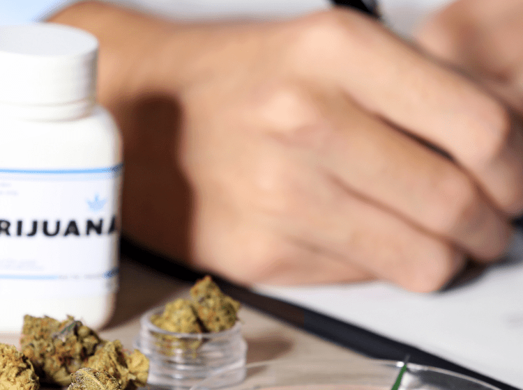 doctor writing marijuana prescription for veteran with ptsd