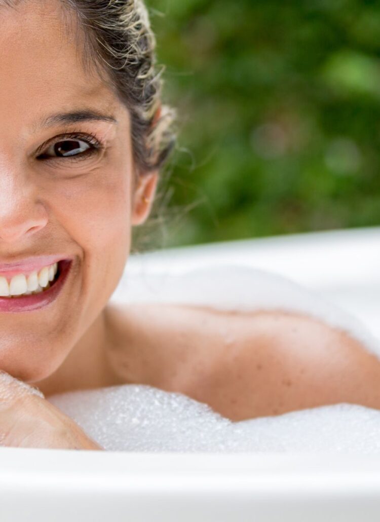 woman soaking in outdoor hot tub to help relieve chronic pain