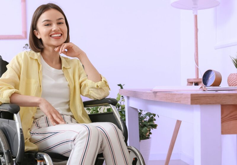 young woman in wheelchair loving her new home she is independent in