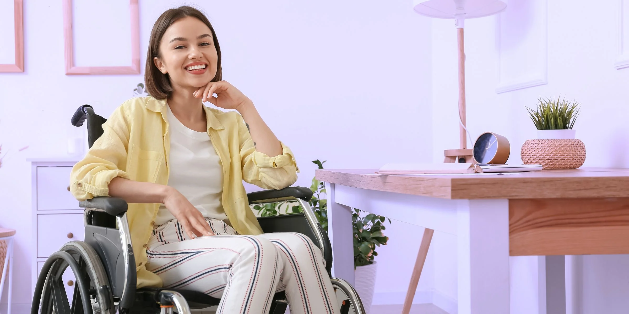 young woman in wheelchair loving her new home she is independent in