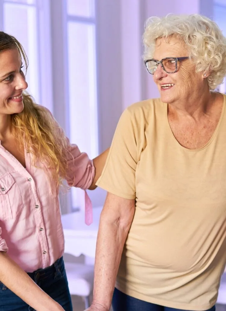 Young daughter helping her mom get used to her new nursing home