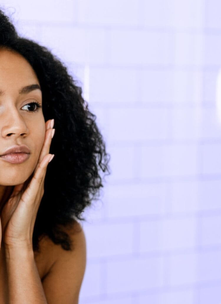 woman looking in the mirror at her appearance