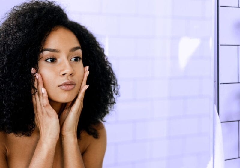 woman looking in the mirror at her appearance