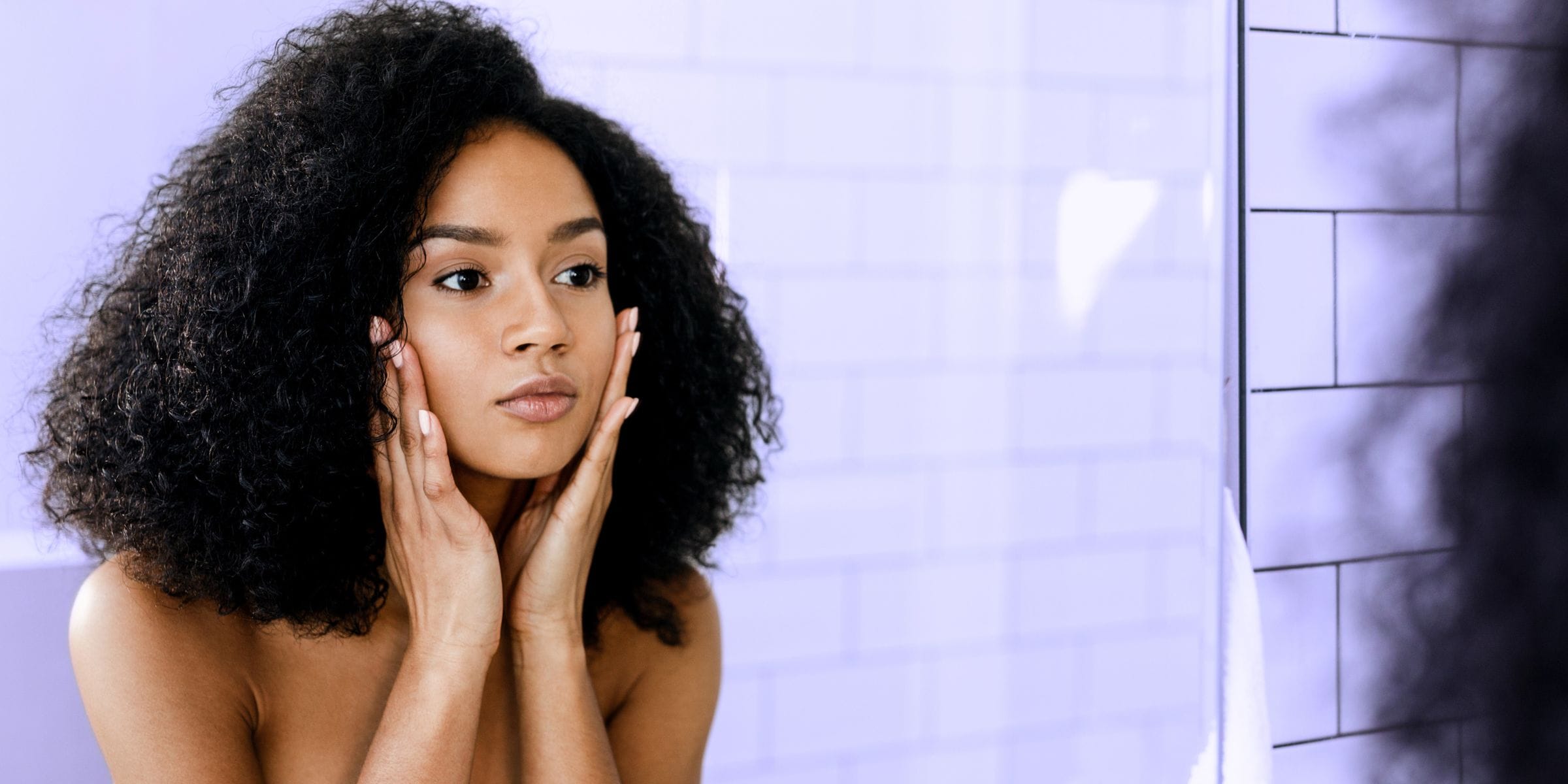 woman looking in the mirror at her appearance