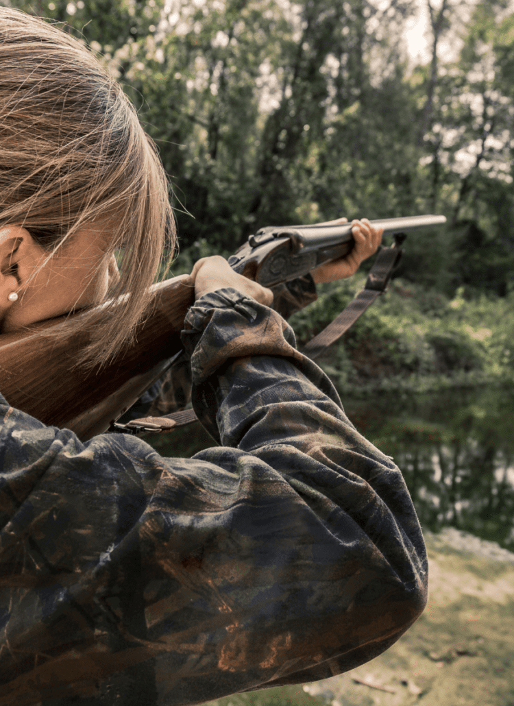 woman in camouflage hunting deer safely outdoors