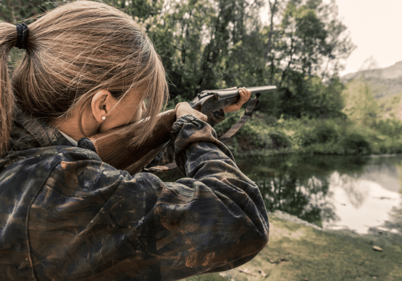 woman in camouflage hunting deer safely outdoors