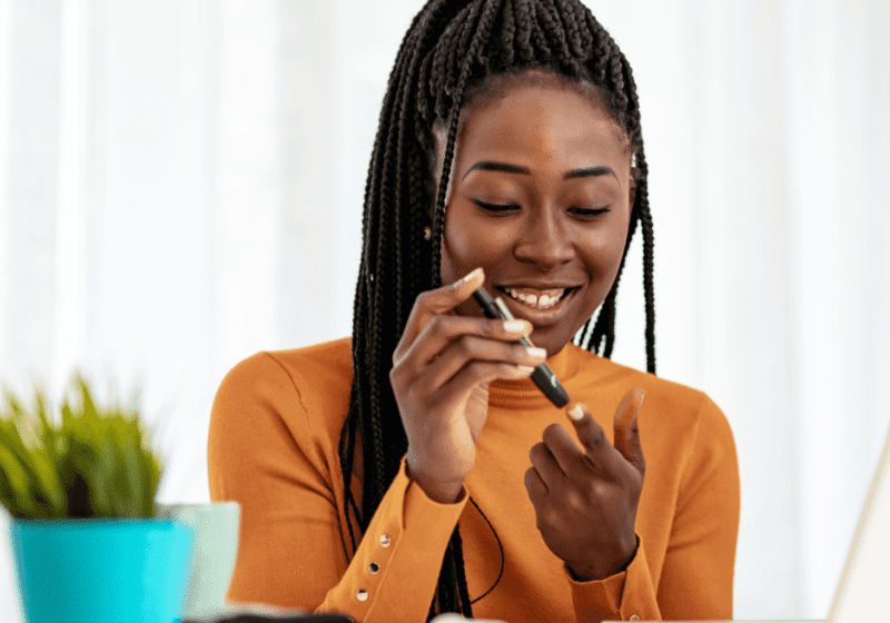 young black women with diabetes tests her blood sugar levels to manager peripheral artery disease