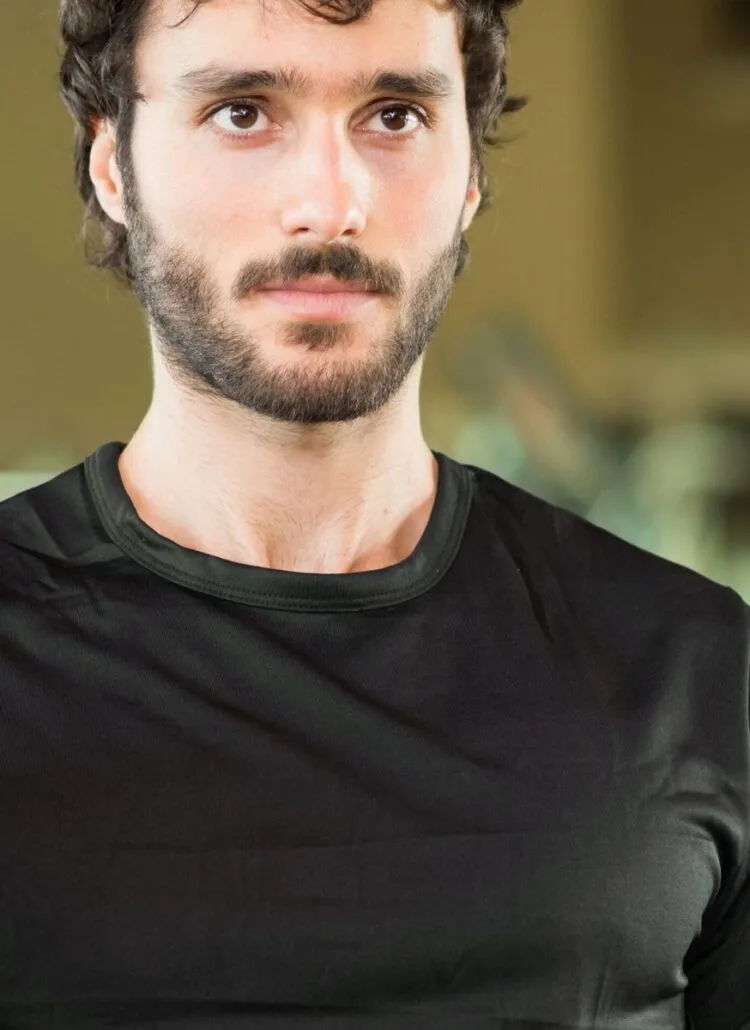 man lifting weights in the gym thinking about muscle recovery