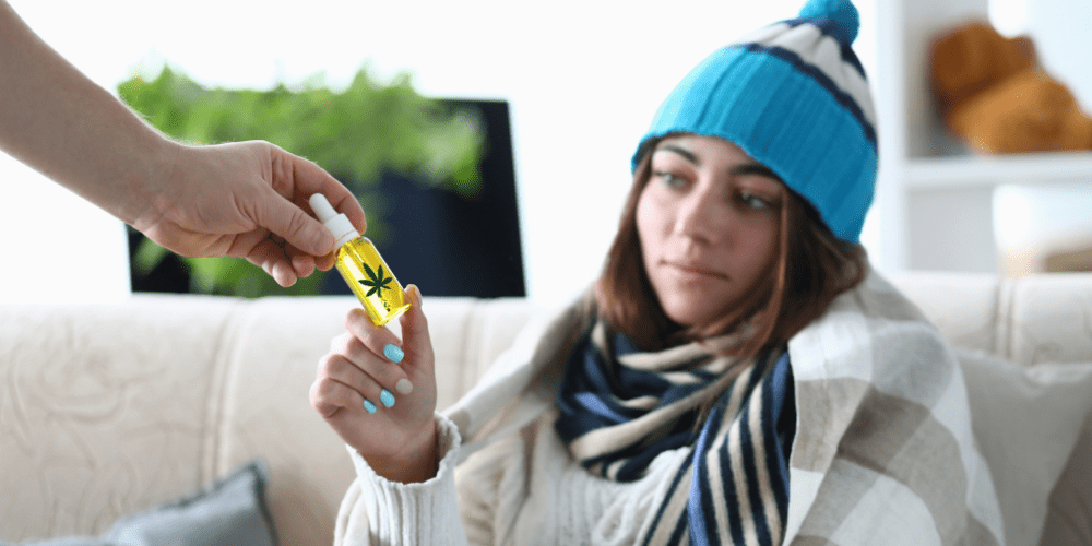 woman in blue hat trying CBD oil for first time