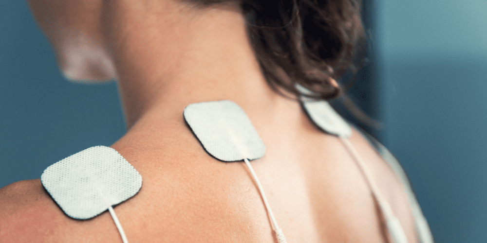 woman with fibromyalgia pain using tens machine