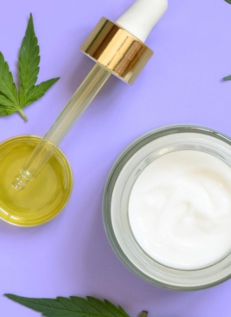 cannabis leaves cbd oil weed cream on purple background