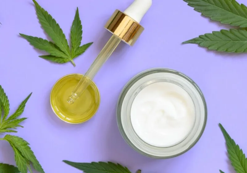 cannabis leaves cbd oil weed cream on purple background