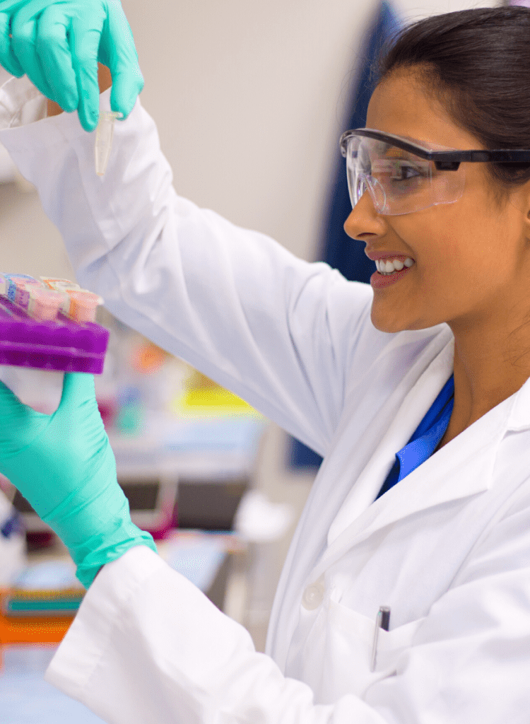 young female indian scientist studying blood samples in clinical research trial