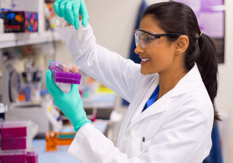 young female indian scientist studying blood samples in clinical research trial