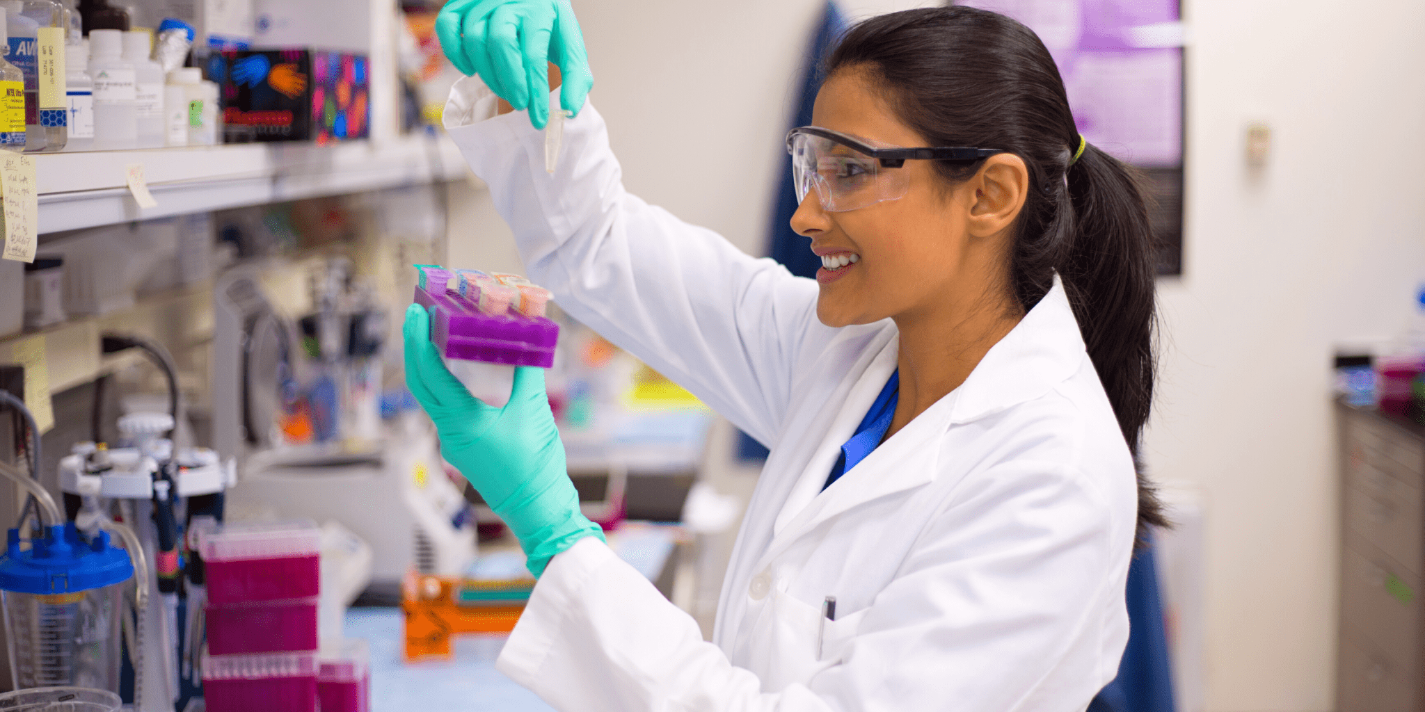 young female indian scientist studying blood samples in clinical research trial