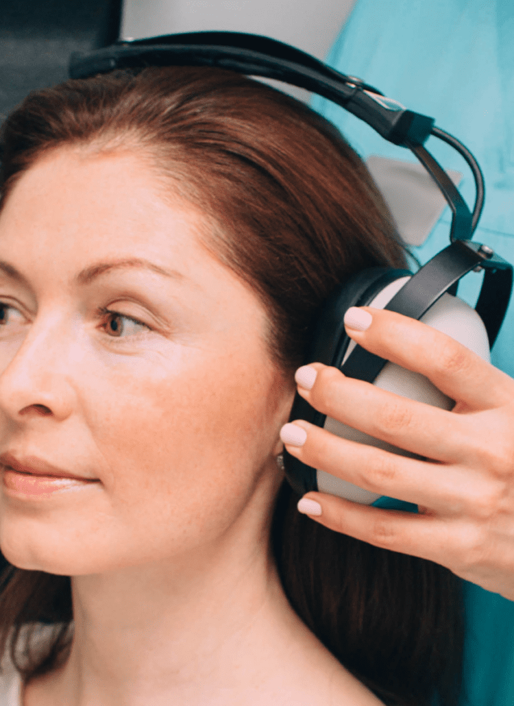 woman getting her hearing tested by audiologist