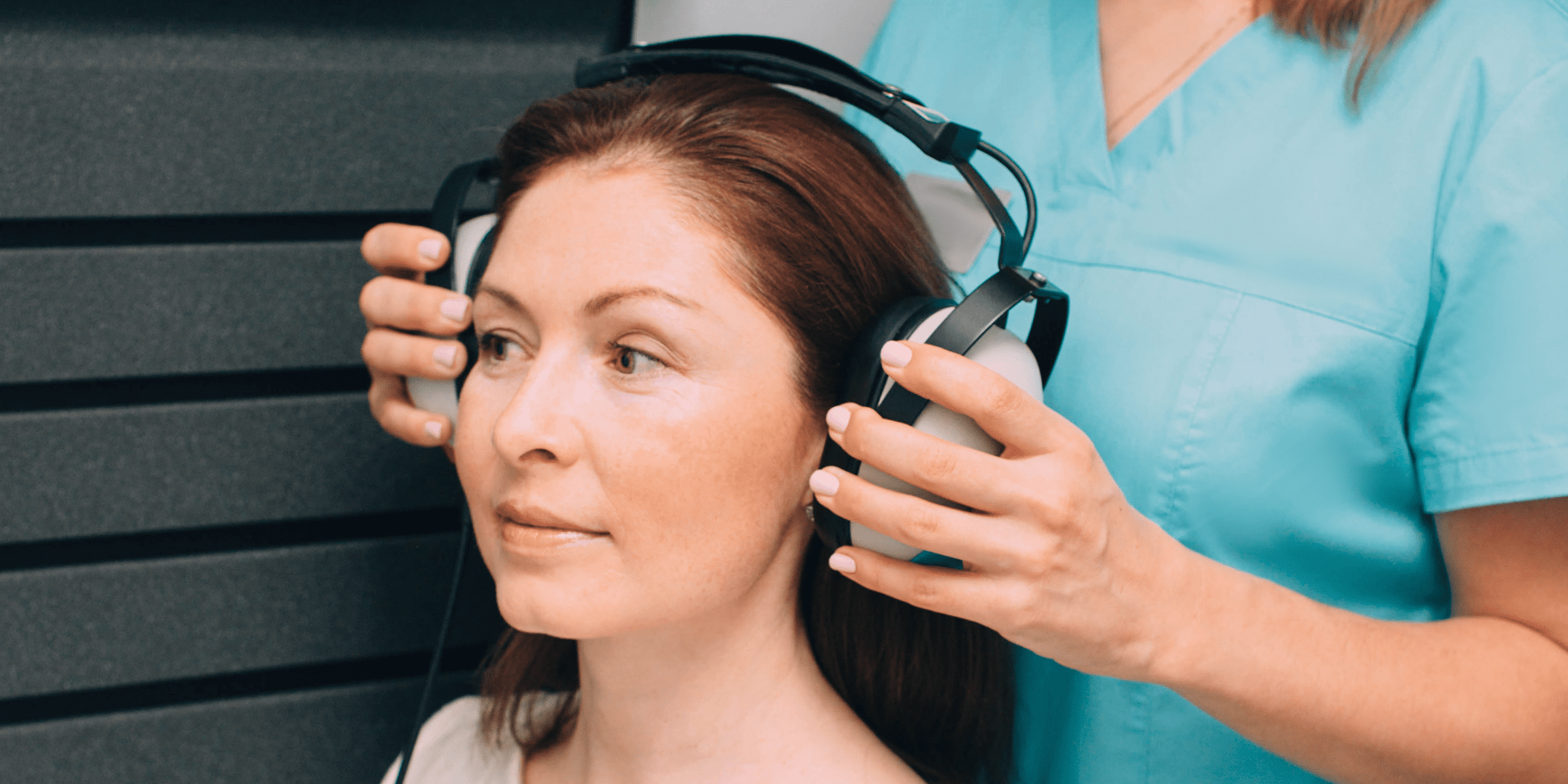 woman getting her hearing tested by audiologist