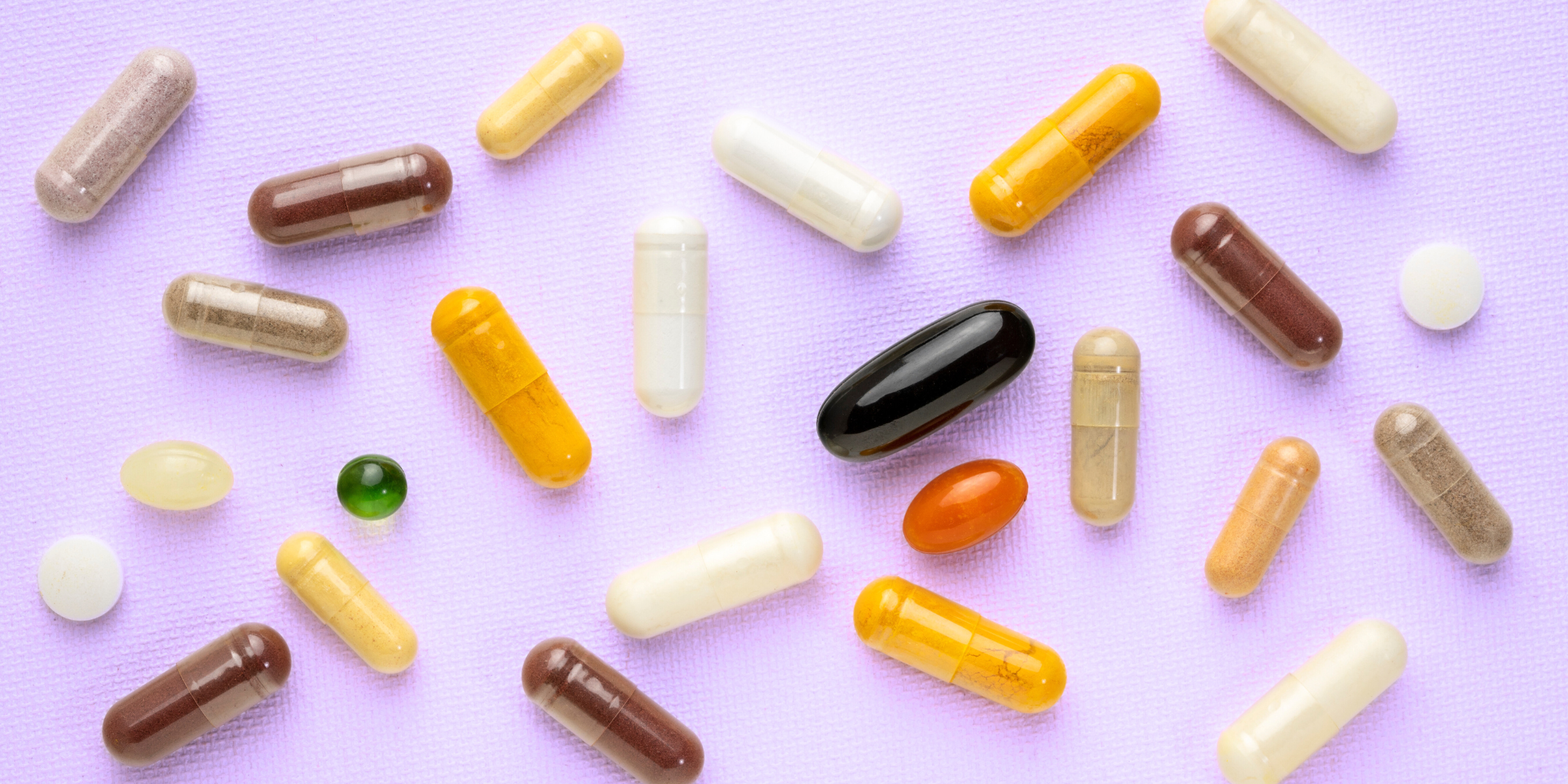vitamins and supplements against a purple background
