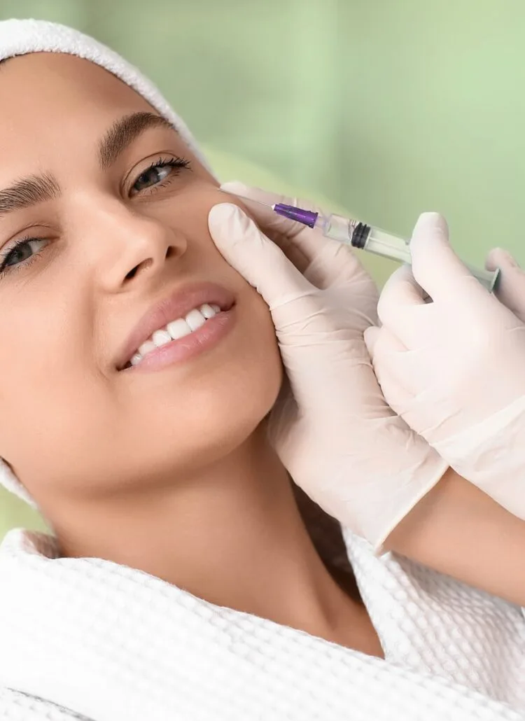 woman getting filler injected into her face to smooth out wrinkles