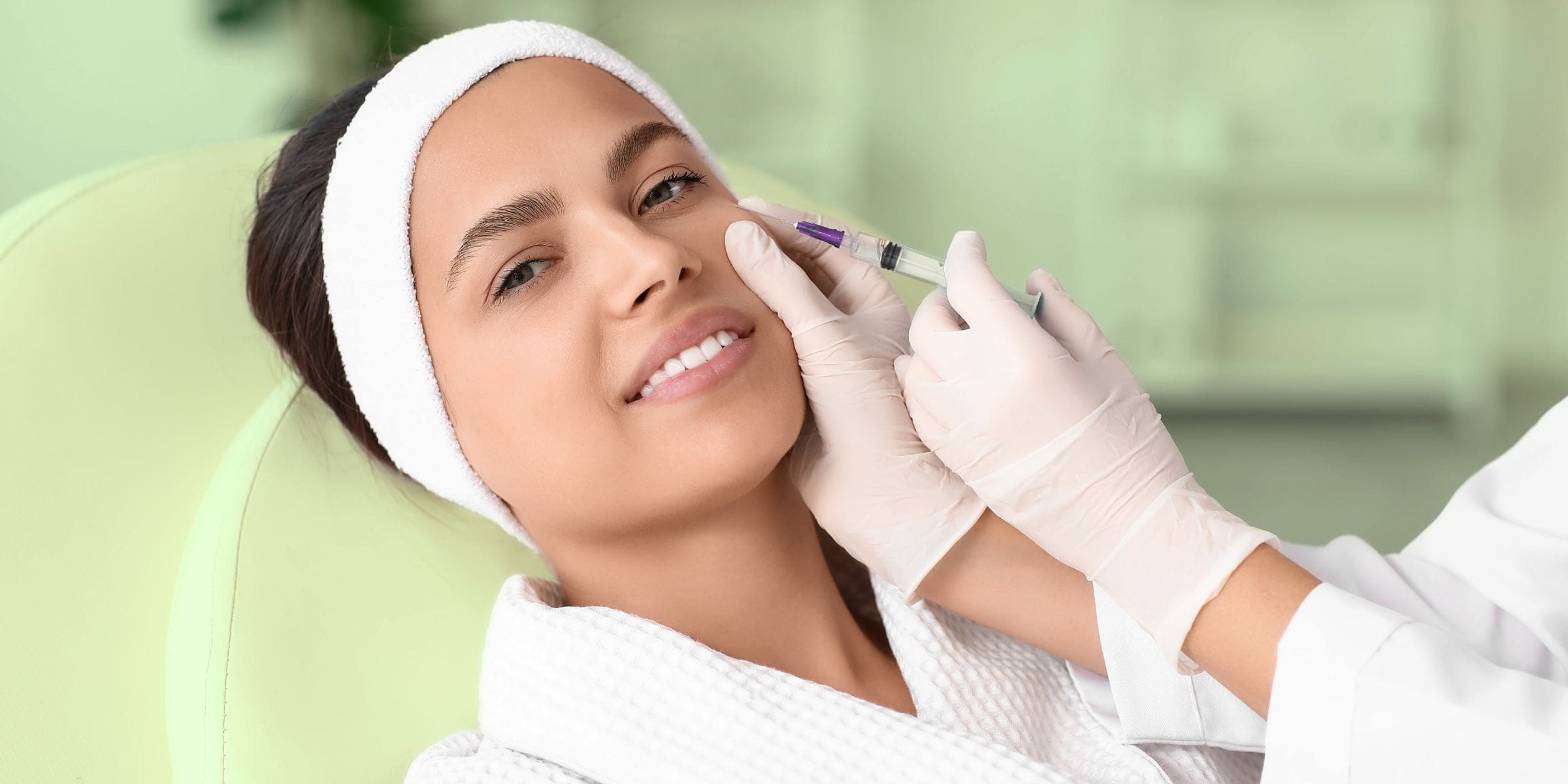 woman getting filler injected into her face to smooth out wrinkles