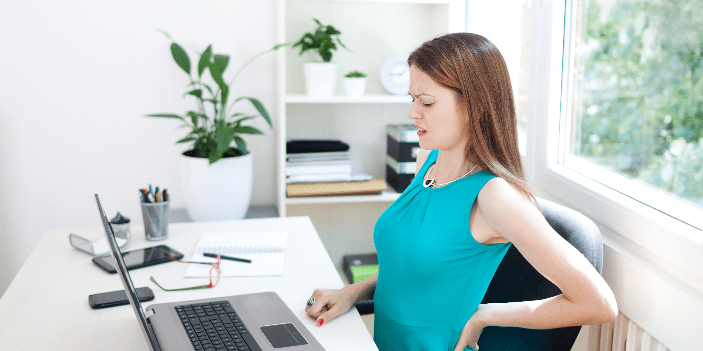 woman with pinched nerves in back sitting in office chair