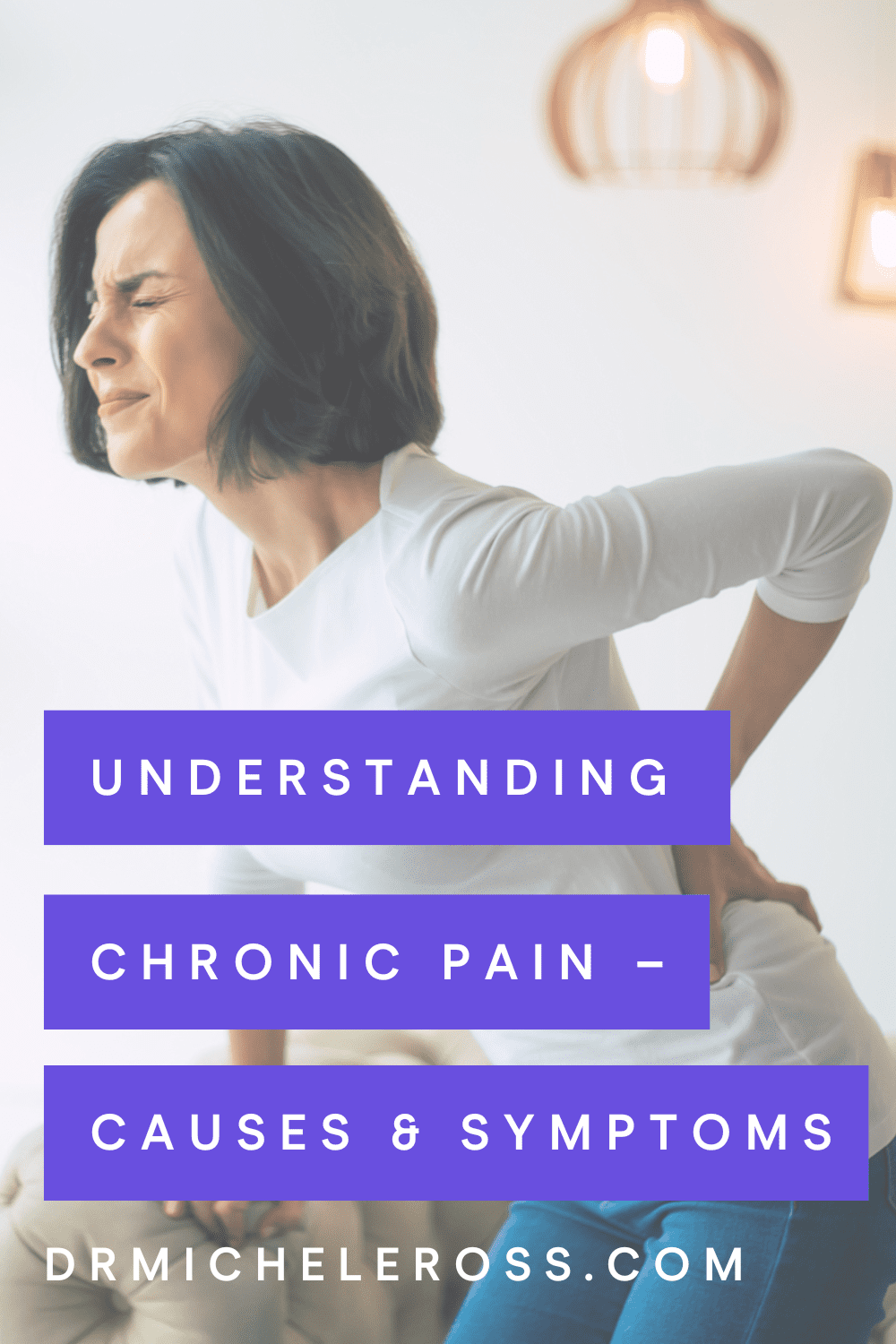 woman holding back chronic pain not sure of causes or treatment