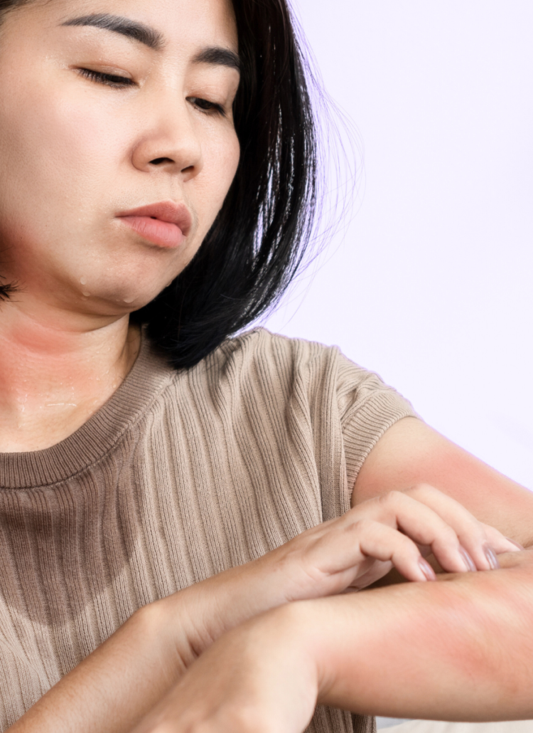 asian woman sweating scratching red rash with unknown health issues purple bedroom