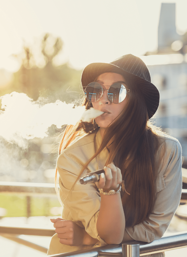 woman in hat and sunglasses smoking medical marijuana