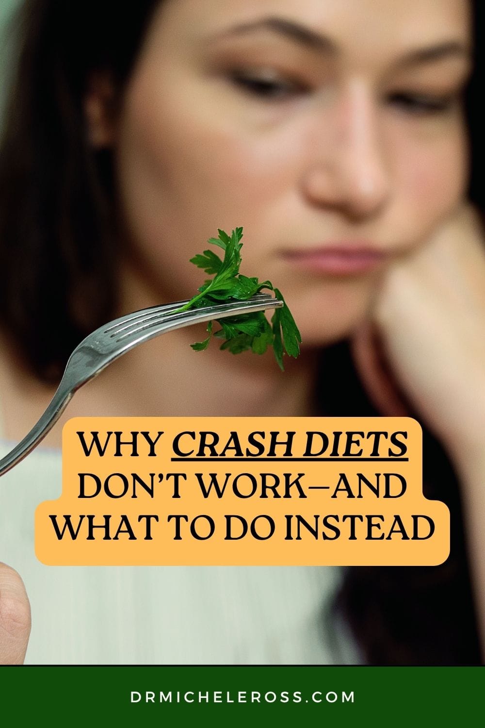 woman on a crash diet looking sad holding one bite of salad on her fork so hungry