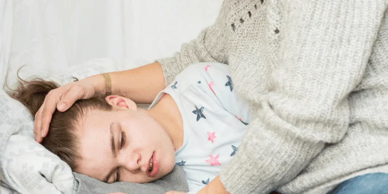 mother holding young girl with seizures