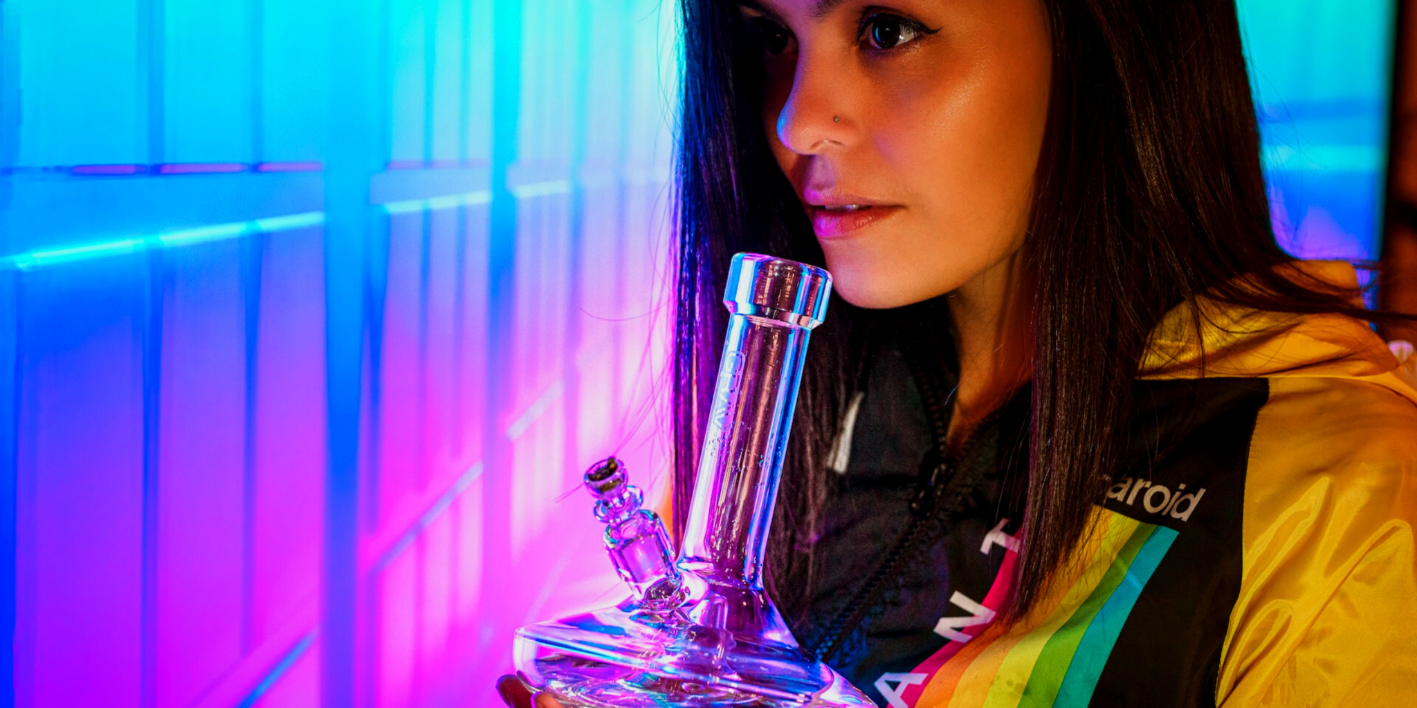 Young woman smoking marijuana out of glass bong
