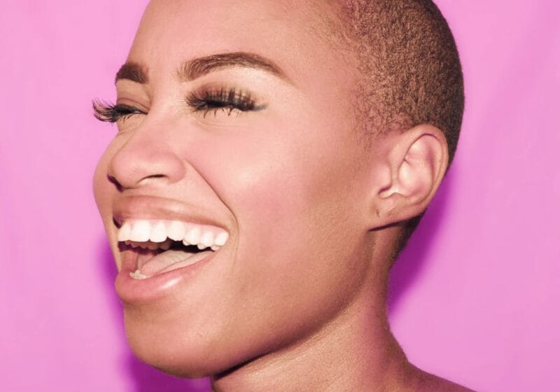 beautiful black woman smiling against pink background perfect oral health