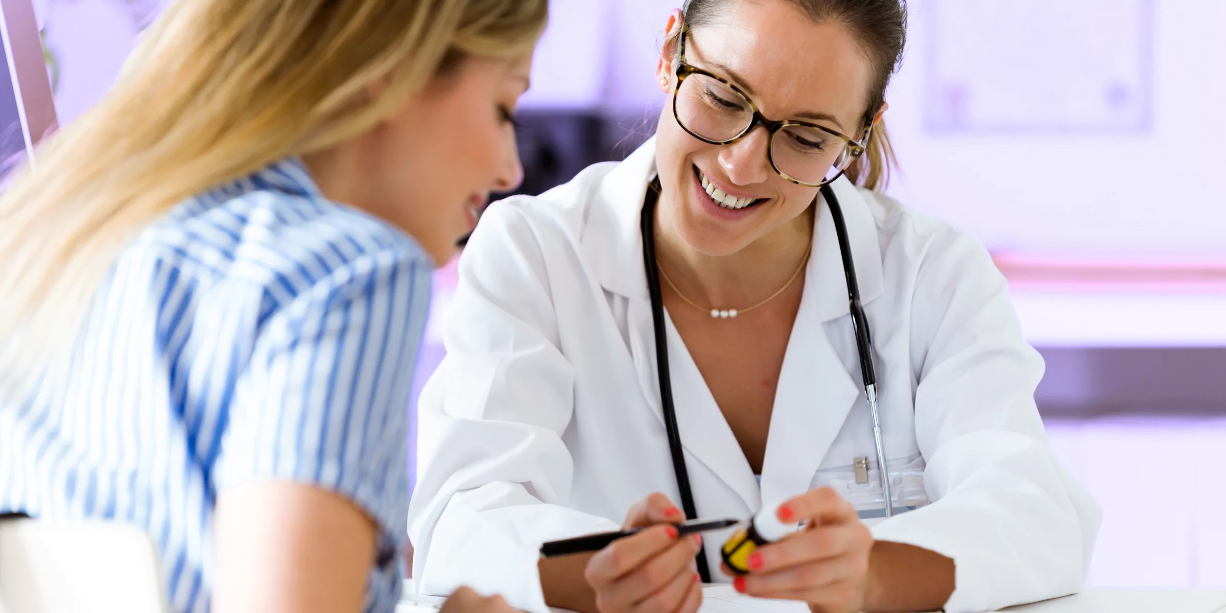 doctor going over medications to quit smoking with female patient