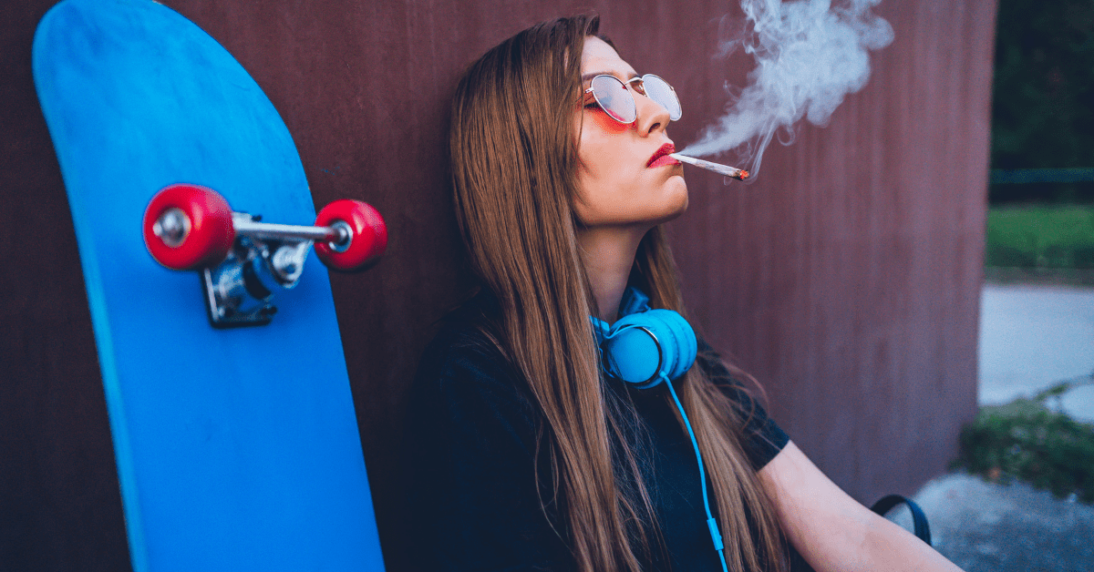 young woman smoking smelly weed joint