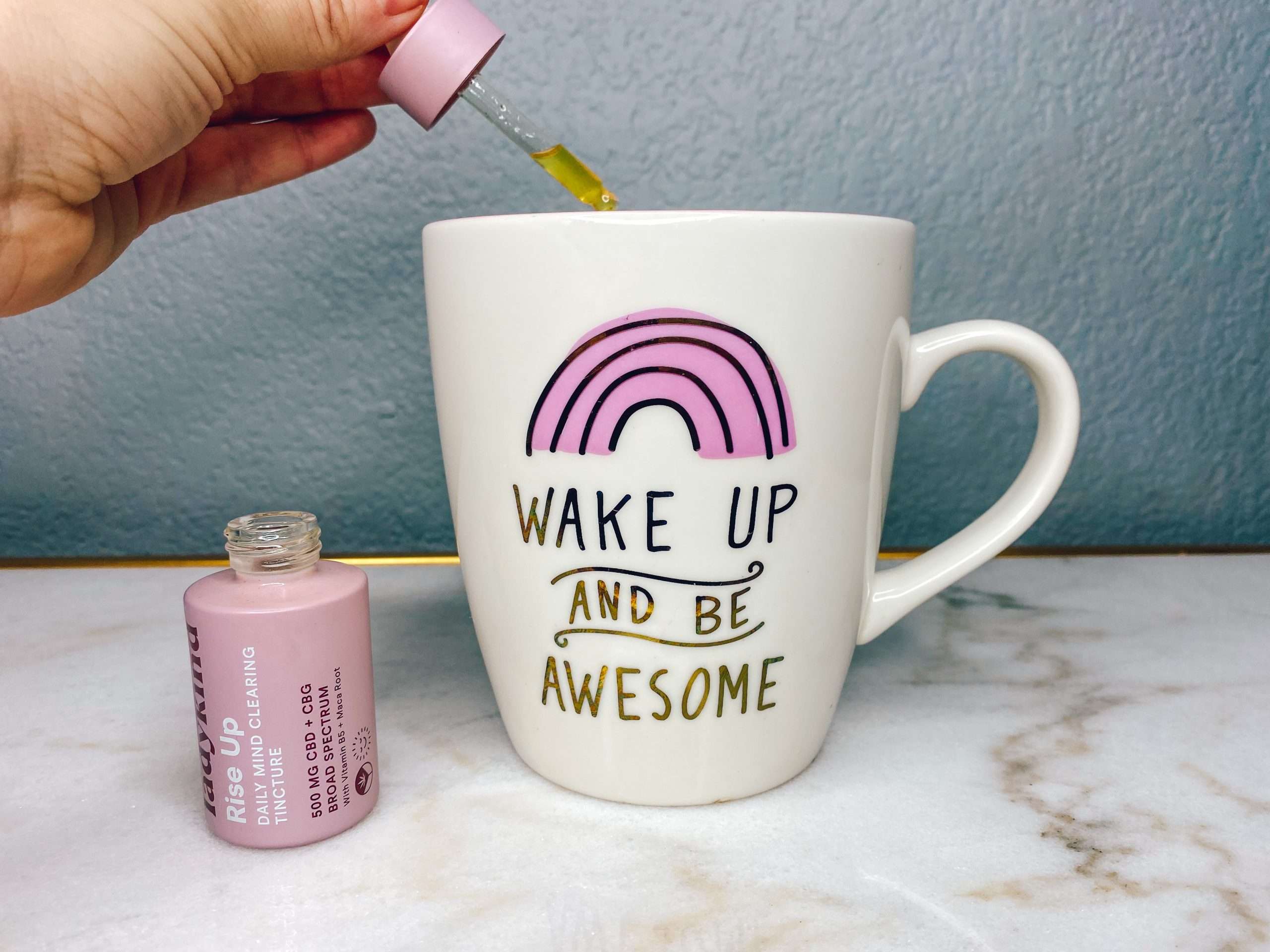 cbd oil drops in wake up and be awesome pink coffee cup