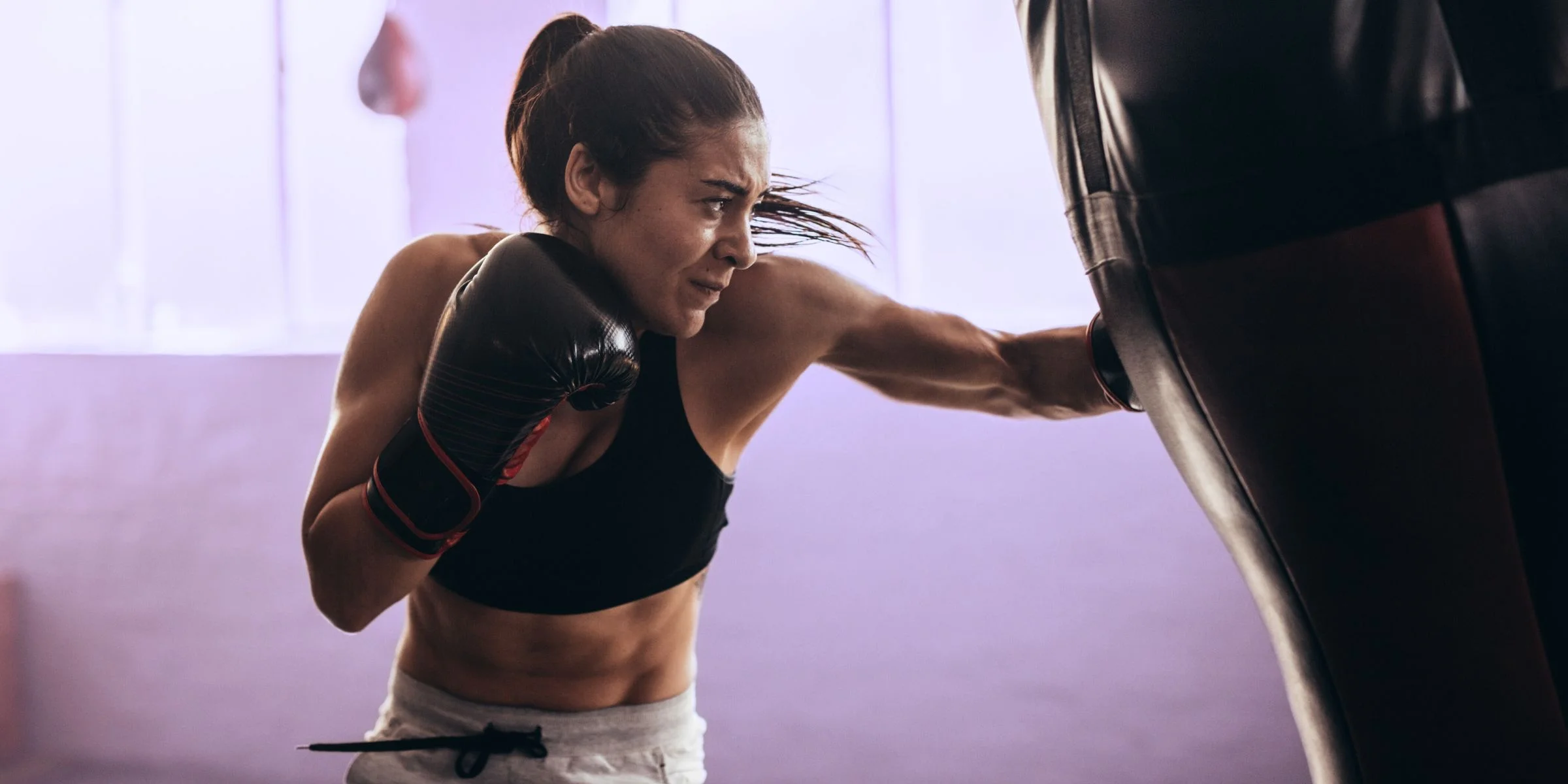 woman doing heart pounding activity of kickboxing for stress management
