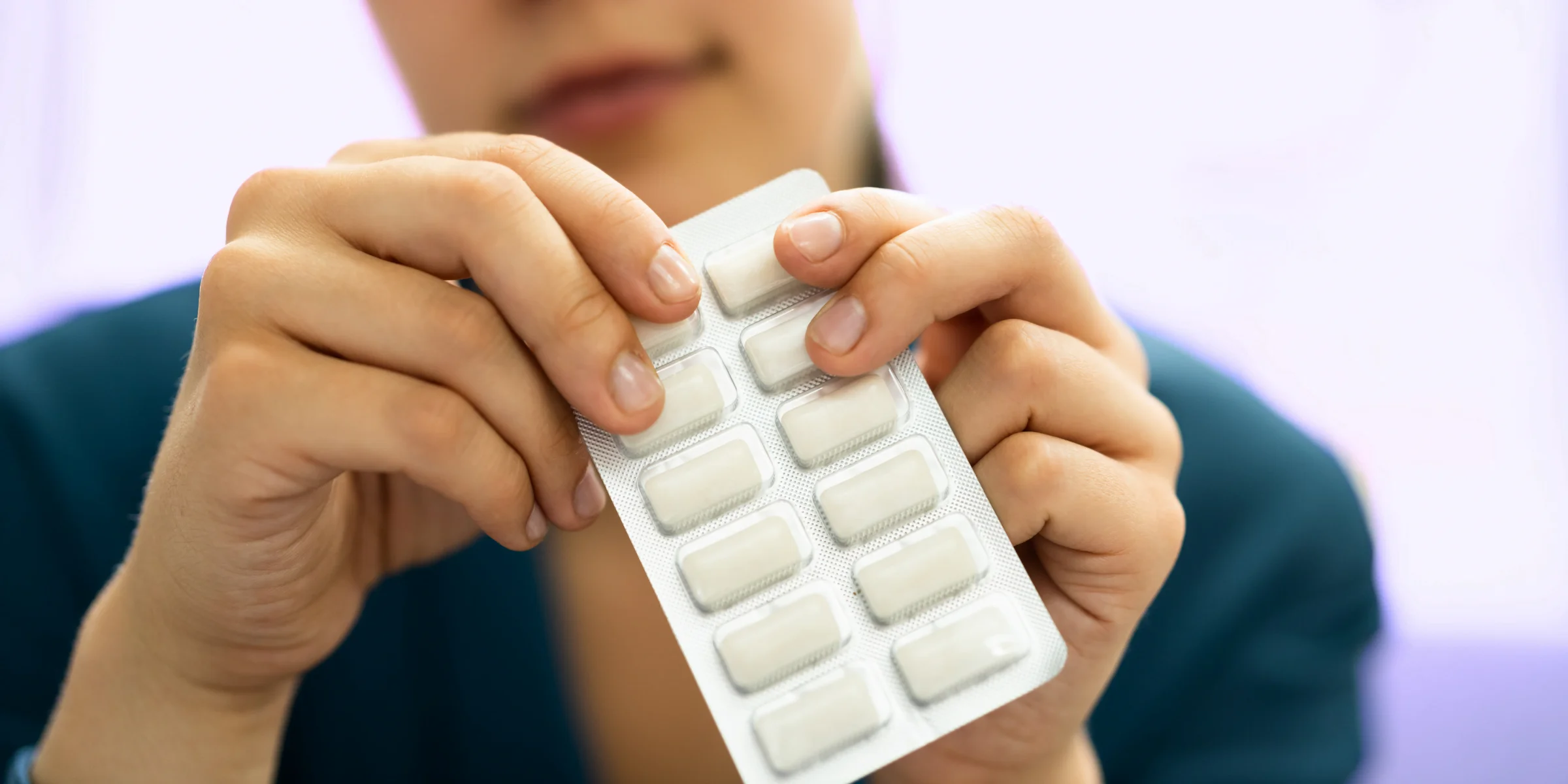 woman using nicotine replacement gum to quit smoking