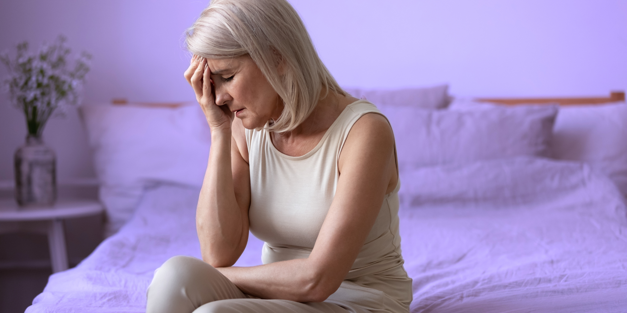 woman in purple bedroom upset with cognitive effects of aging