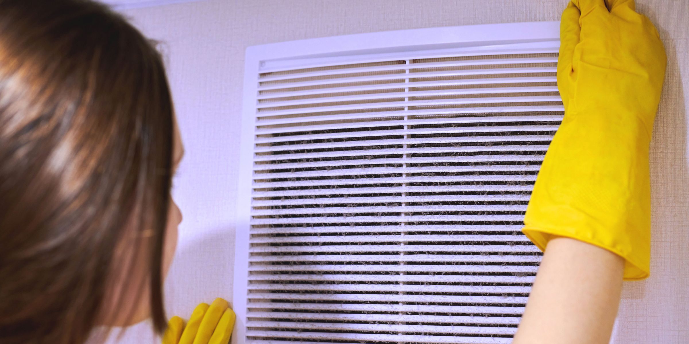 woman scheduled regular HVAC filter replacements for good indoor air quality
